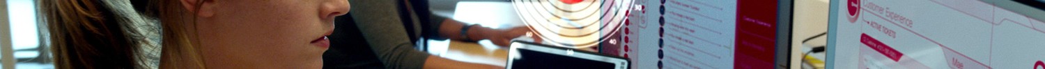 Eine Frau sitzt in einem Büro vor einem Computer.
